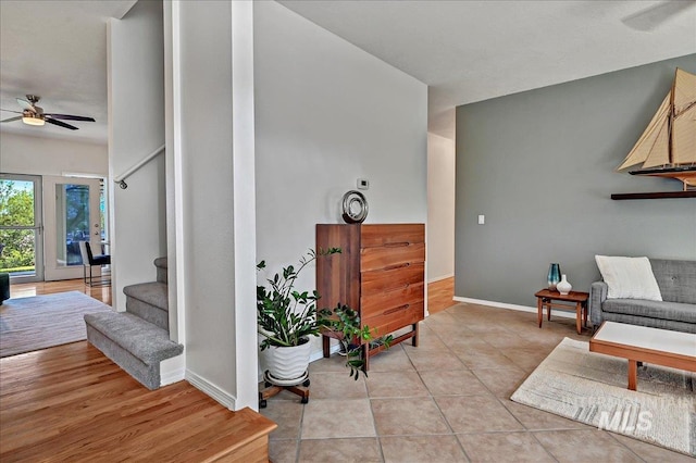 2942 E Eastgate Dr, Boise, ID 83716 - living area with a ceiling fan, stairway, baseboards, and light tile patterned flooring