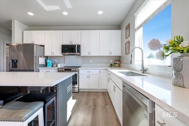 837 Trout Creek Way, Kimberly, ID 83314 - kitchen featuring stainless steel appliances, white cabinetry, a kitchen bar, and recessed lighting