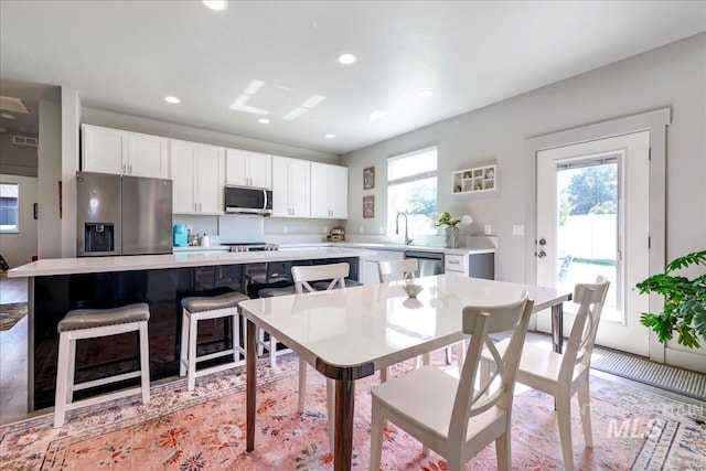 837 Trout Creek Way, Kimberly, ID 83314 - kitchen with appliances with stainless steel finishes, light countertops, white cabinetry, recessed lighting, and a breakfast bar area
