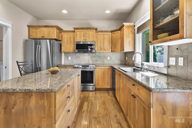 3031 N Christian Way, Meridian, ID 83646 - kitchen with appliances with stainless steel finishes, light wood-type flooring, light stone counters, backsplash, and recessed lighting