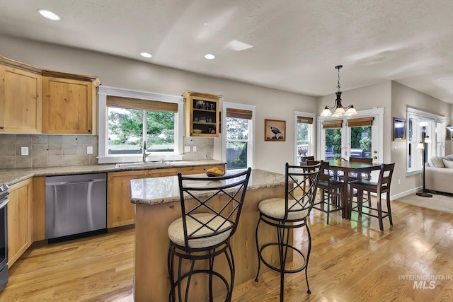 3031 N Christian Way, Meridian, ID 83646 - kitchen featuring stainless steel dishwasher, a chandelier, light wood finished floors, tasteful backsplash, and recessed lighting