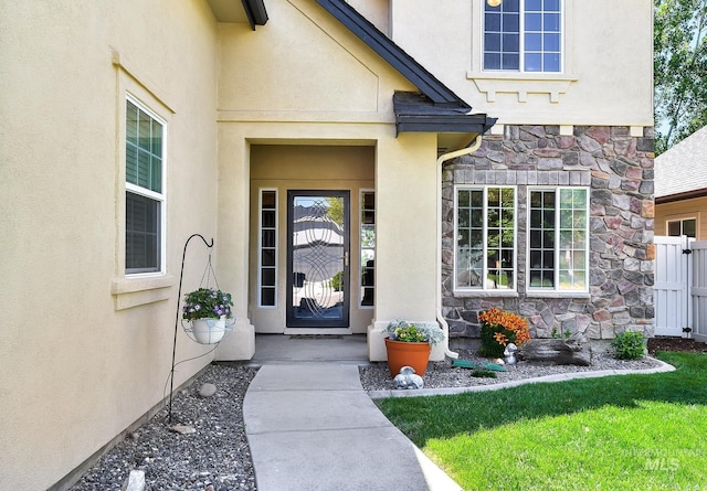 3031 N Christian Way, Meridian, ID 83646 - property entrance with stone siding, stucco siding, and a yard