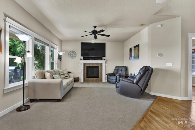 3031 N Christian Way, Meridian, ID 83646 - living area with a ceiling fan, a tile fireplace, and wood finished floors