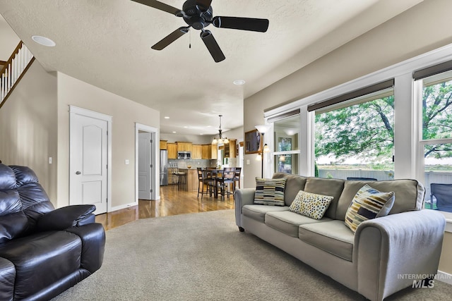3031 N Christian Way, Meridian, ID 83646 - living area with ceiling fan, a chandelier, wood finished floors, a textured ceiling, and recessed lighting