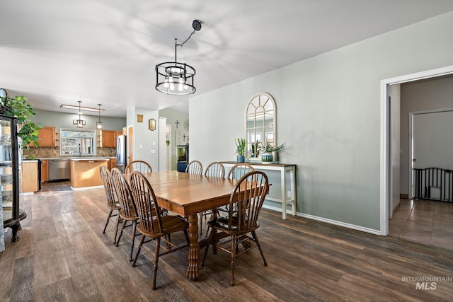 dining area featuring dark wood-type flooring