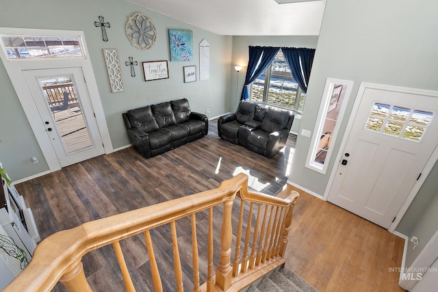 living room with vaulted ceiling and light hardwood / wood-style floors