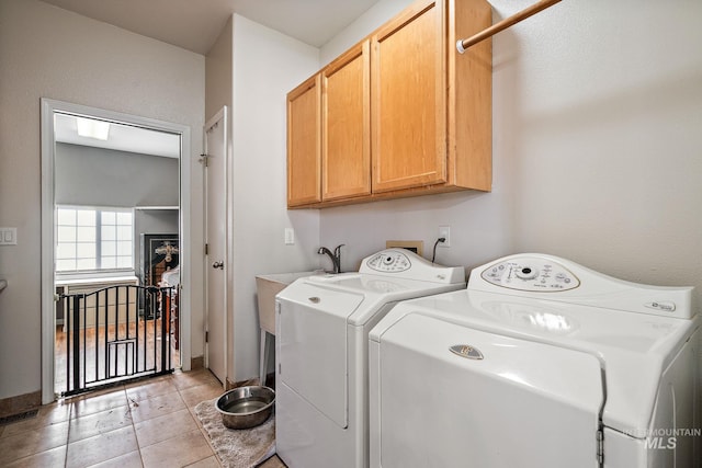 washroom with cabinets, light tile patterned flooring, and separate washer and dryer