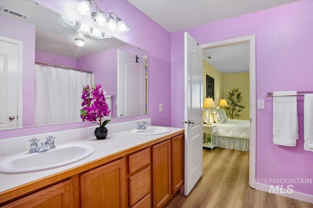 2888 W Wilder St, Meridian, ID 83642 - full bathroom featuring wood finished floors, double vanity, and ensuite bath