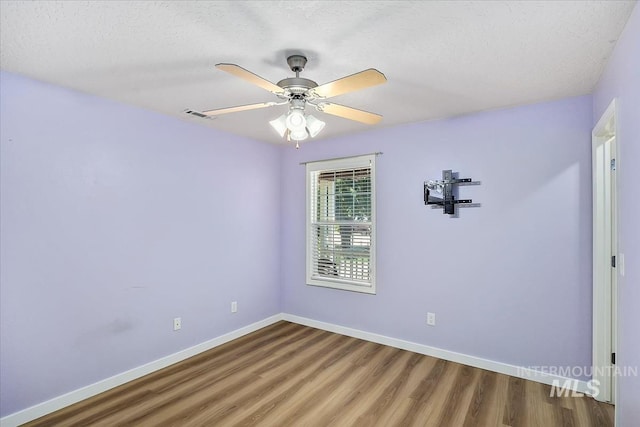 2888 W Wilder St, Meridian, ID 83642 - empty room with wood finished floors, a ceiling fan, and a textured ceiling