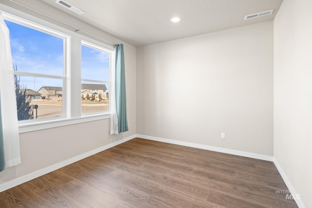 spare room with hardwood / wood-style floors