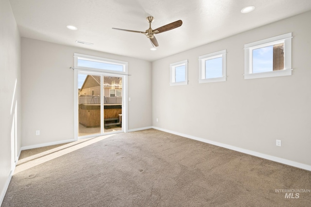 carpeted empty room featuring ceiling fan