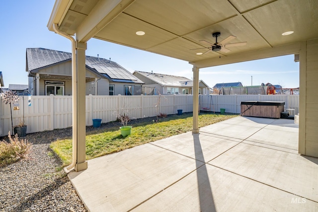 view of patio with a hot tub and ceiling fan