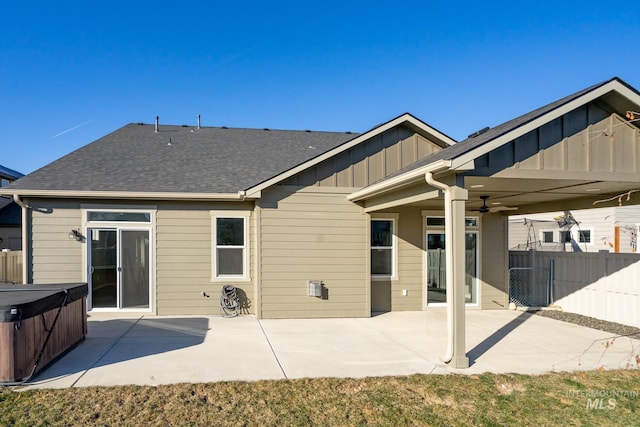 rear view of house with a patio area, a hot tub, and ceiling fan