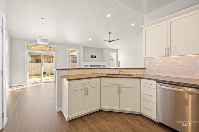 kitchen with wood-type flooring, dishwasher, sink, and white cabinets