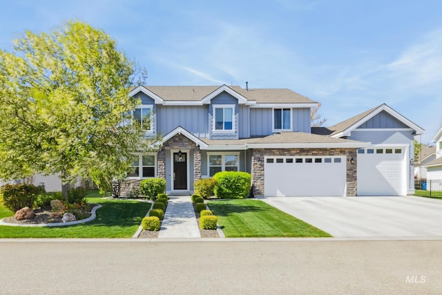12371 S Abbott Downing Way, Nampa, ID 83686 - view of front facade featuring a garage, a front lawn, stone siding, board and batten siding, and concrete driveway