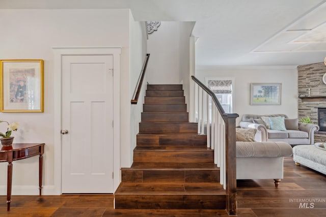12371 S Abbott Downing Way, Nampa, ID 83686 - stairway with ornamental molding, a stone fireplace, and wood finished floors