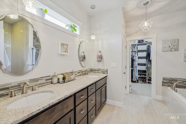 12371 S Abbott Downing Way, Nampa, ID 83686 - full bathroom featuring double vanity, decorative backsplash, a sink, and a bathtub