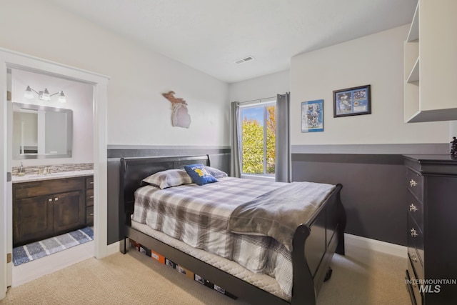12371 S Abbott Downing Way, Nampa, ID 83686 - bedroom with ensuite bathroom, light carpet, and visible vents