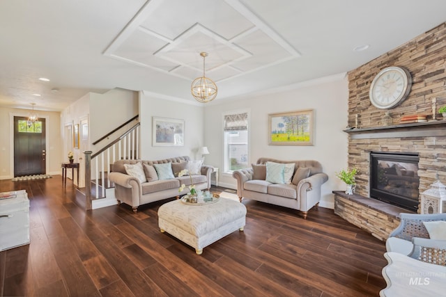 12371 S Abbott Downing Way, Nampa, ID 83686 - living room with a chandelier, dark wood finished floors, stairway, and a fireplace