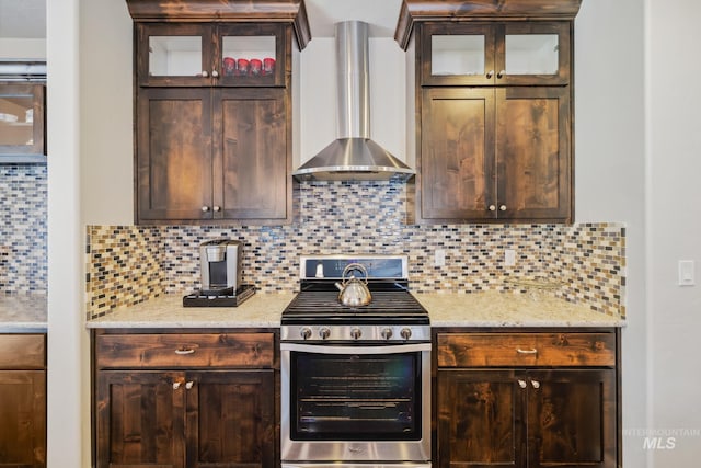 12371 S Abbott Downing Way, Nampa, ID 83686 - kitchen with stainless steel range with gas cooktop, dark brown cabinets, decorative backsplash, and wall chimney exhaust hood