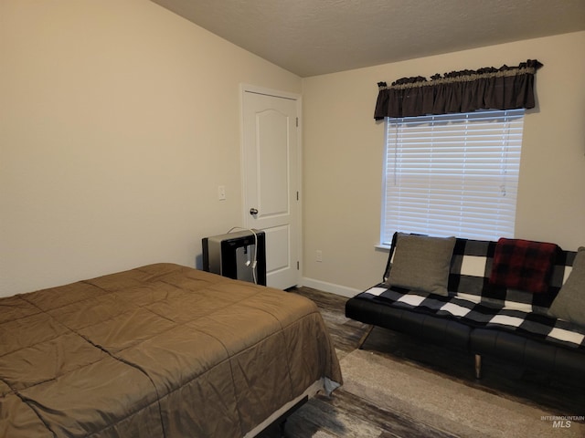 bedroom featuring dark hardwood / wood-style floors and vaulted ceiling