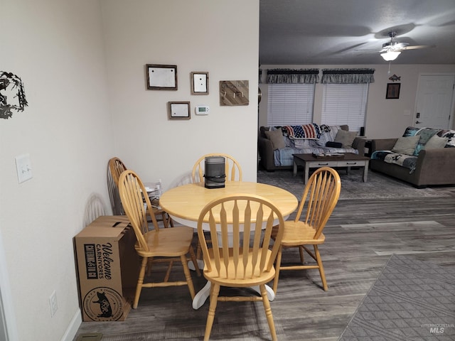 dining area with ceiling fan and wood-type flooring