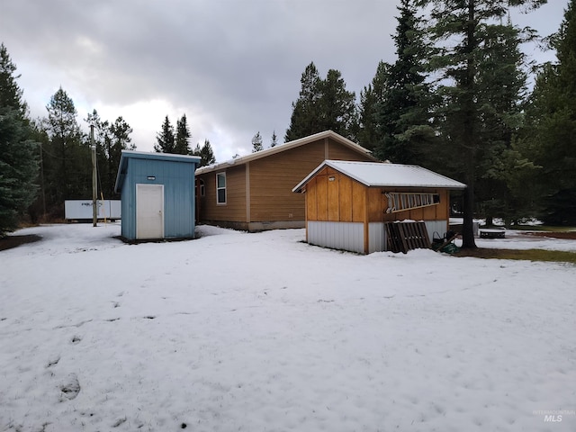 snow covered house with a shed