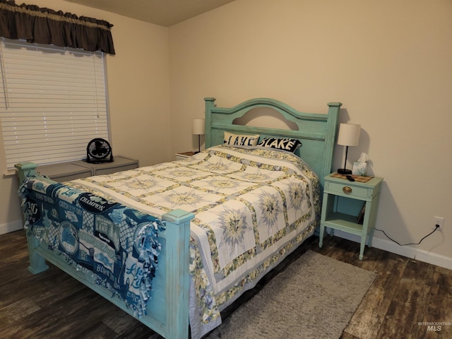 bedroom featuring dark hardwood / wood-style flooring