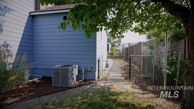 view of side of home with central air condition unit