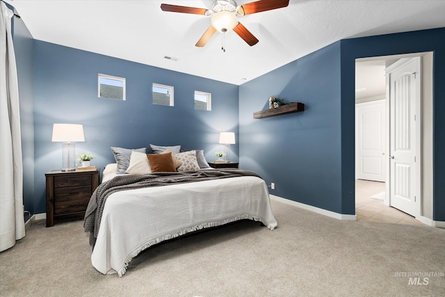 bedroom featuring ceiling fan and light carpet