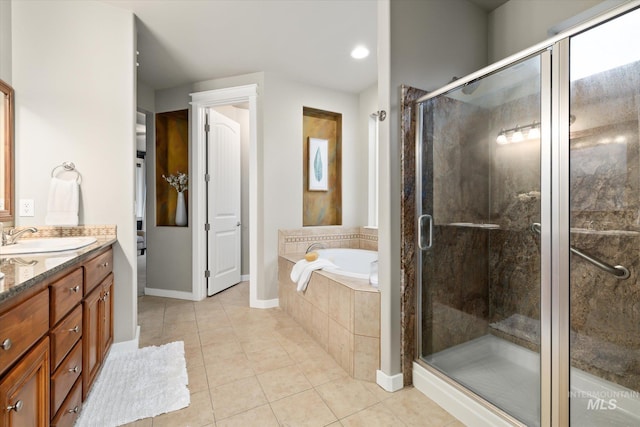 bathroom with tile patterned flooring, vanity, and shower with separate bathtub