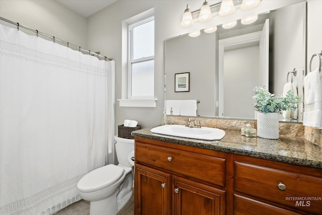 bathroom featuring tile patterned floors, vanity, toilet, and walk in shower