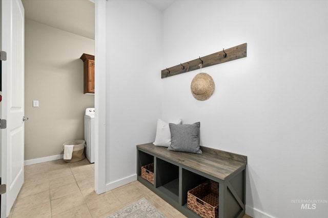 mudroom featuring light tile patterned floors and washer / dryer