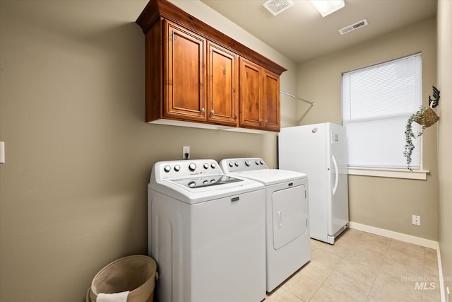 washroom featuring washer and clothes dryer and cabinets