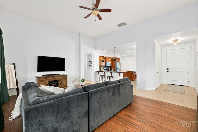 living room featuring ceiling fan and wood-type flooring