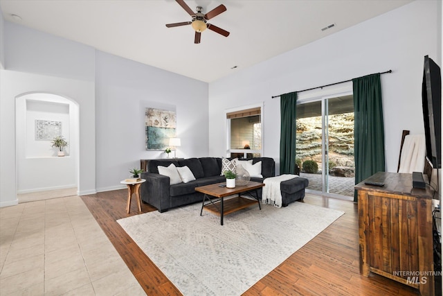 living room with ceiling fan and light hardwood / wood-style flooring