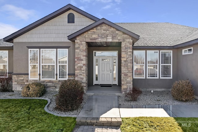 property entrance with stone siding and stucco siding