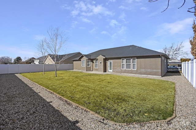 view of front of house with a patio, a front yard, and a fenced backyard