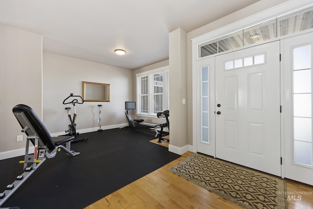 entryway with baseboards and wood finished floors