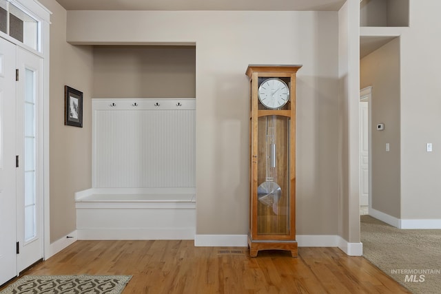 mudroom featuring baseboards and wood finished floors