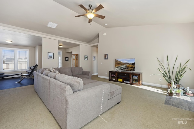 carpeted living area with ceiling fan, visible vents, baseboards, and vaulted ceiling