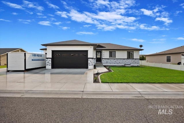 prairie-style house featuring stucco siding, an attached garage, a front yard, fence, and driveway