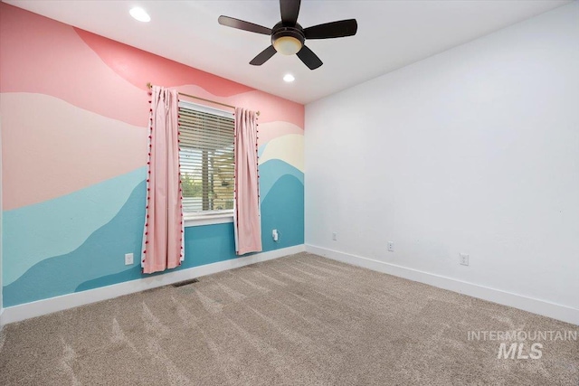 carpeted empty room featuring baseboards, visible vents, a ceiling fan, and recessed lighting