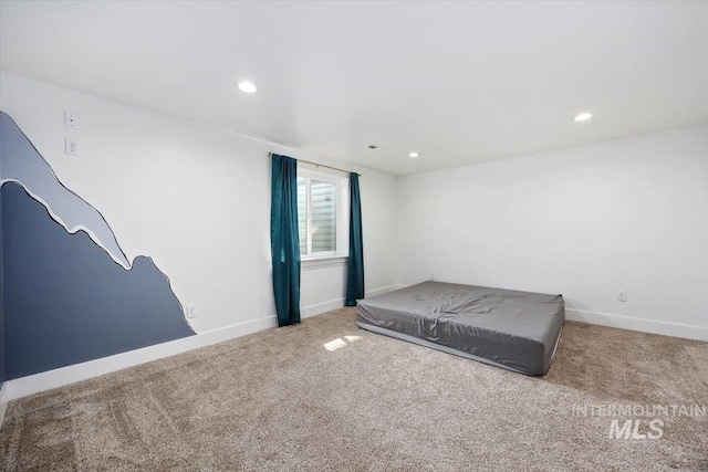 unfurnished bedroom featuring carpet floors, baseboards, and recessed lighting