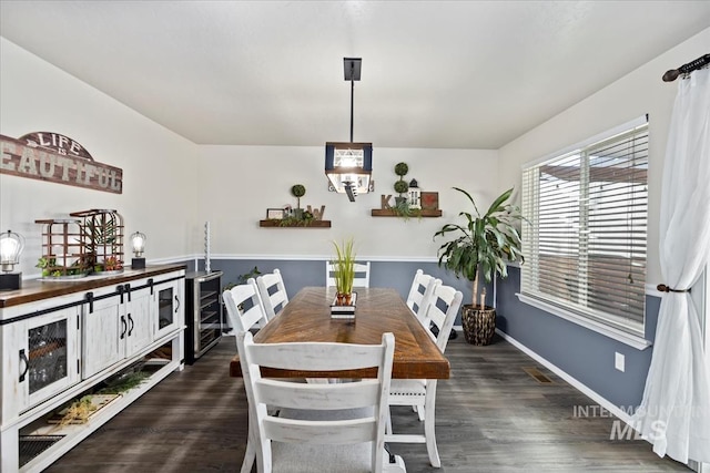 dining space with dark hardwood / wood-style flooring and beverage cooler