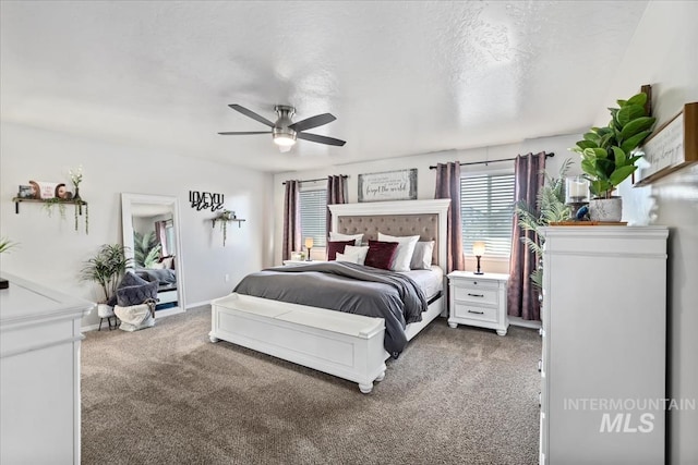 bedroom with ceiling fan, carpet, and a textured ceiling