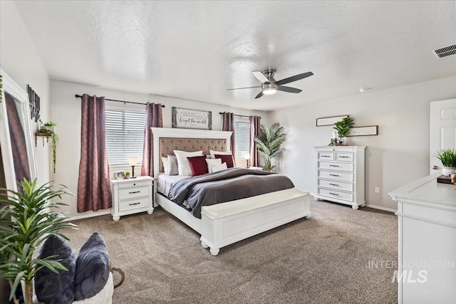 carpeted bedroom with a textured ceiling and ceiling fan