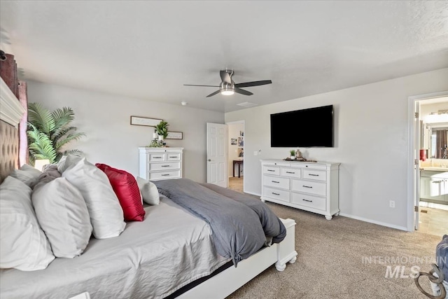 carpeted bedroom with ceiling fan and connected bathroom