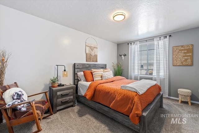 bedroom with carpet and a textured ceiling