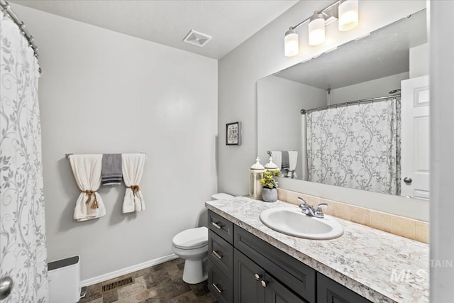 bathroom with toilet and vanity